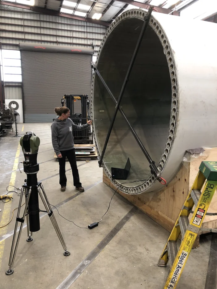 Technician running a laser tracker for onsite dimensional inspection